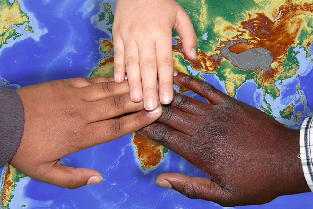 Children's hands on a map of the world Image by Ralph from Pixabay